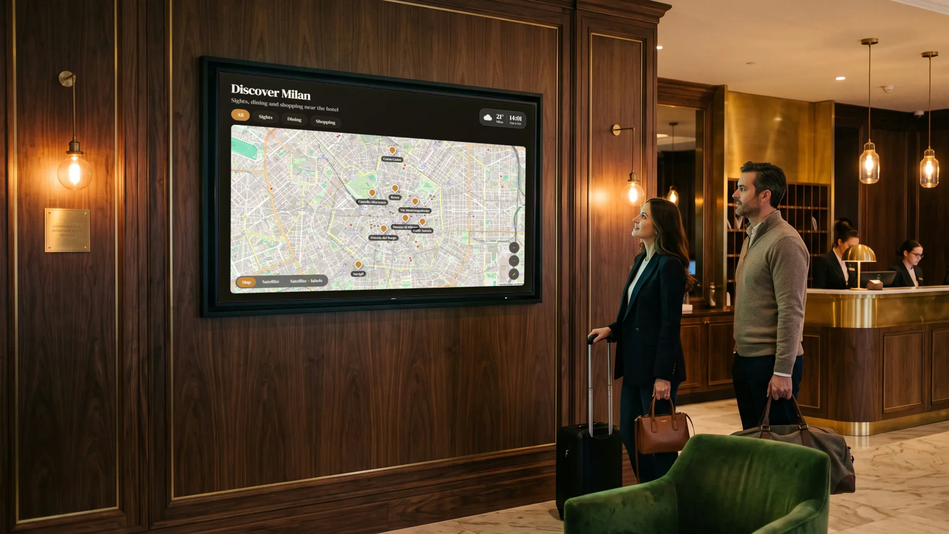Guests in a hotel lobby in front of a screen with a city map and places to visit.