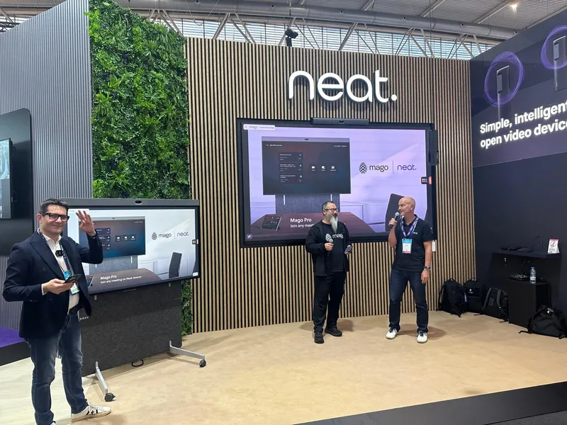 Three presenters on the Neat stage showcasing Mago on Neat Board and Neat Bar at ISE 2026